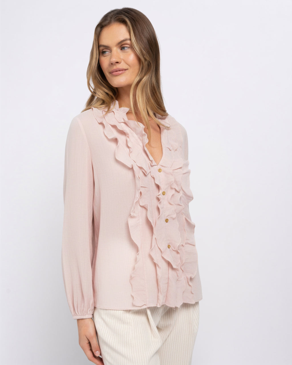 Side view of the Khloe Top in Ballerina pink, showing the ruffle trim and button placket detail